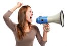 Young woman shouting through megaphone Young woman shouting through megaphone