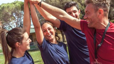 Three athletes with coach