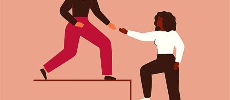 A woman reaches down to help a colleague up the stairs, illustrating allyship A woman reaches down to help a colleague up the stairs, illustrating allyship