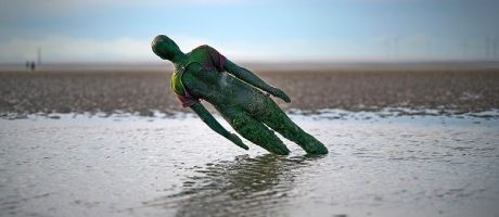 A statue in Antony Gormley’s art installation ‘Another Place’ at Crosby Beach subsides in the sand in Liverpool, England. To illustrate that without adequate funding for university teaching, the UK government is undermining the creative industries.