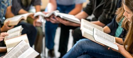 A group of students read the bible