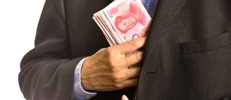 A businessman pocketing Chinese banknotes