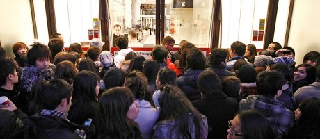 Shoppers wait outside Selfridges as the store opens it doors on the first day of its winter sale on Boxing Day. To illustrate that some universities are enrolling hundreds of research students despite warnings.