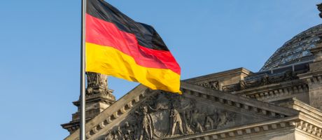  German flag fluttering in front of the Reichstag building in Berlin