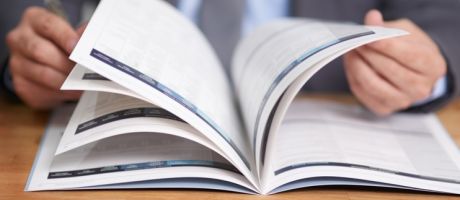 A close-up of a person flicking though a book 