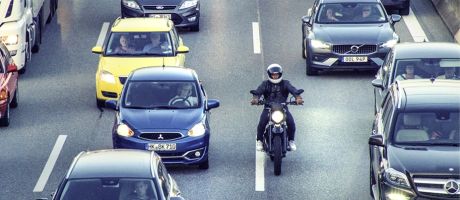 A motorbike slips through a traffic jam, symbolising rapid completion of a PhD A motorbike slips through a traffic jam, symbolising rapid completion of a PhD