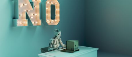 A robot working on a computer with "no" in big letters on the wall, illustrating the rejection of AI