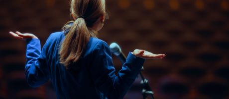 A public speaker shrugs A public speaker shrugs