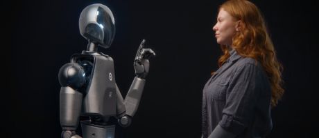 A robot talks to a woman, illustrating AI interactions
