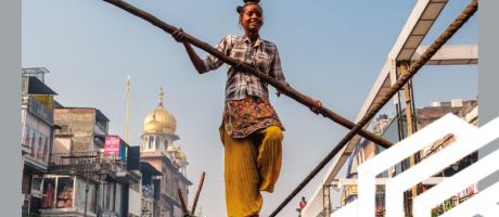 A young tightrope walker balances on a rope with a pole and a pot on her head, in Old Delhi, India. To illustrate a rebalancing of the ratings as lower-income nations are narrowing the gap on wealthier competitors A young tightrope walker balances on a rope with a pole and a pot on her head, in Old Delhi, India. To illustrate a rebalancing of the ratings as lower-income nations are narrowing the gap on wealthier competitors