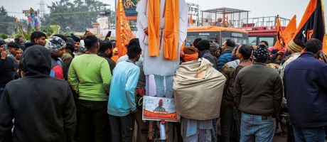 Devotees gather near an effigy of Indian prime minister Narendra Modi at the Ram Mandir Temple to illustrate Political attacks on Indian HEIs must end