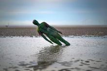 A statue in Antony Gormley’s art installation ‘Another Place’ at Crosby Beach subsides in the sand in Liverpool, England. To illustrate that without adequate funding for university teaching, the UK government is undermining the creative industries. A statue in Antony Gormley’s art installation ‘Another Place’ at Crosby Beach subsides in the sand in Liverpool, England. To illustrate that without adequate funding for university teaching, the UK government is undermining the creative industries.
