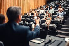 A speaker nominates people in the audience to ask questions