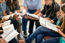 A group of students read the bible