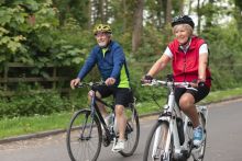Senior couple wearing sports clothing and cycling helmets on a summers day Senior couple wearing sports clothing and cycling helmets on a summers day