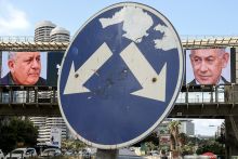 A road sign stands in front of a large billboard featuring Israel’s prime minister Benjamin Netanyahu (R) of the Likud party and former military chief and leader of the centrist Yashar party, Gadi Eisenkot, in Ramat Gan, Israel on 20 October 2026. 