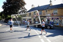 Players carry the goal posts away from the river following a football match, Bourton-on-the-Water, England. To illustrate a late surge in UK student visa refusals. Players carry the goal posts away from the river following a football match, Bourton-on-the-Water, England. To illustrate a late surge in UK student visa refusals.