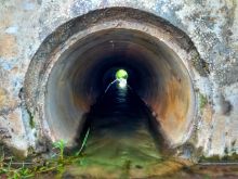 A narrowing pipe with water flowing through it A narrowing pipe with water flowing through it