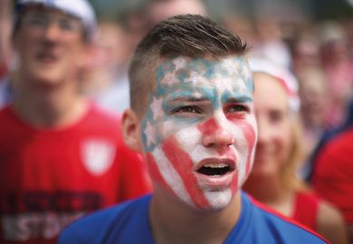 Young man with American flag painted on face Young man with American flag painted on face