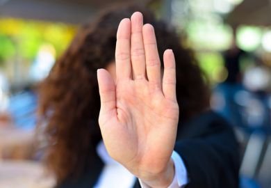A woman holding up her palm
