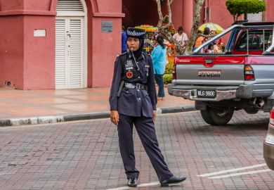 A traffic policewoman wearing hijab at duties, Malacca, Malaysia