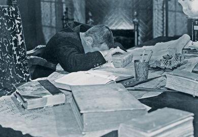 Academic with his heads in his hands