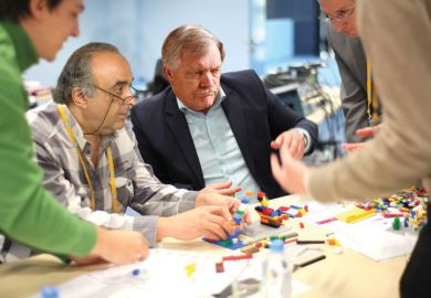Adults playing with Lego