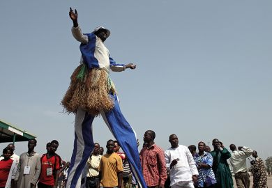 A participant on stilts performs during the Abuja Cultural Carnival in Nigeria. To illustrate Africa rising in the World University Rankings