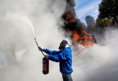 A protester sprays a fire extinguisher during an anti-government demonstration in central Tirana on October 15, 2026,
