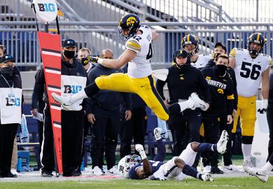 Shaun Beyer of the Iowa Hawkeyes leaps over Lamont Wade of the Penn State Nittany Lions  to illustrate Gambling threat ‘rising on US campuses’