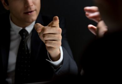 An angry official points his finger An angry official points his finger, symbolising the Trump Administration