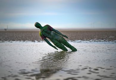 A statue in Antony Gormley’s art installation ‘Another Place’ at Crosby Beach subsides in the sand in Liverpool, England. To illustrate that without adequate funding for university teaching, the UK government is undermining the creative industries.