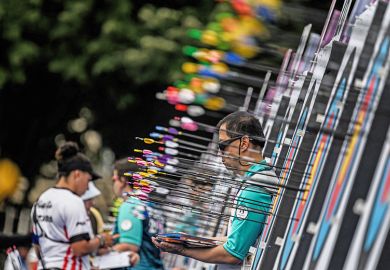 A person looks to be surrounded by arrows as he waits near the targets during an archery competition. To illustrate 'unfair' research income targets for Liverpool’s new academics. A person looks to be surrounded by arrows as he waits near the targets during an archery competition. To illustrate 'unfair' research income targets for Liverpool’s new academics.