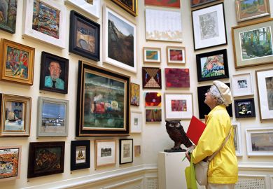 Woman looks at art in gallery