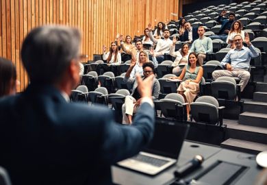 A speaker nominates people in the audience to ask questions A speaker nominates people in the audience to ask questions