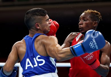 Patrick Chinyemba (R) of Zambia exchanges punches with Alex Winwood of Australia, boxing at the Tokyo 2020 Olympic Games. To illustrate that Australian universities face a bruising election.