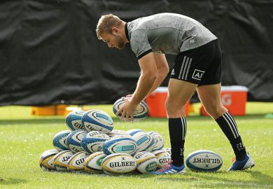 rugby player with pile of balls rugby player with pile of balls