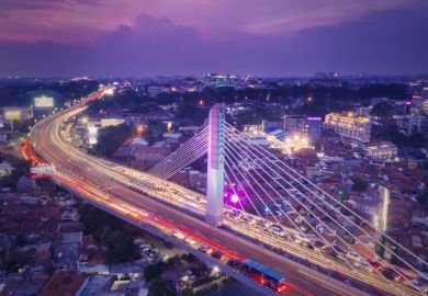  Aerial view of glowing Pasupati overpass at evening in Bandung city