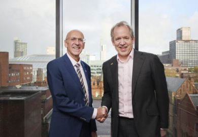 Vice-chancellors of Manchester universities shaking hands. 