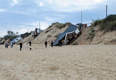 Houses collapsed by a beach Houses collapsed by a beach