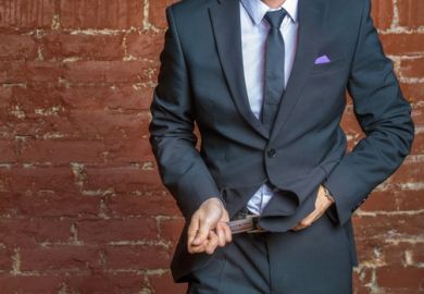 A suited man tightens his belt A suited man tightens his belt