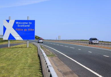 Berwick, UK - May 31, 2010 Cars on the A1 main road crossing the border between England and Scotland, passing the Welcome to Scotalnd sign with a stylised Saint Andrew's Cross scottish flag. Borders in the UK are open with no controls and free movement.