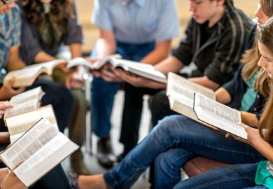 A group of students read the bible