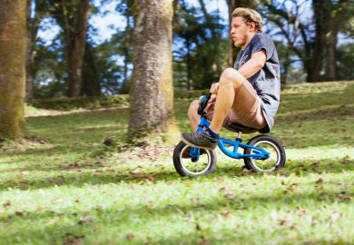 A man rides a child's bicycle, illustrating the need for growth A man rides a child's bicycle, illustrating the need for growth