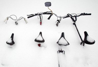Bicycles are buried in snow in Montreal, Canada. To illustrate that the flow of international students to Canada is declining.