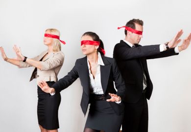 Blindfolded business people holding arms out