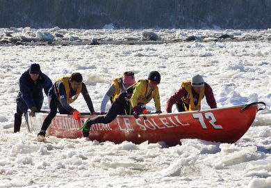 A team from Japan take part in a canoe race on ice, Quebec, illustrating that new international student caps hurt Quebec universities.