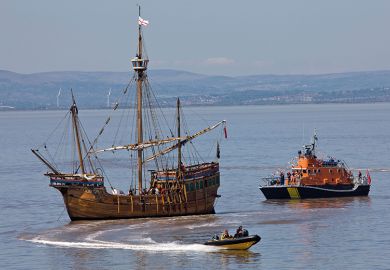 A stranded galleon is approached by a tugboat