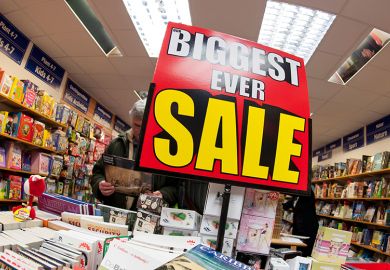 "Biggest ever sale" sign in a bookshop, to illustrate universities looking for cheaper publishing agreements.