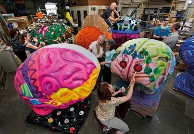 Artists painting brain sculptures